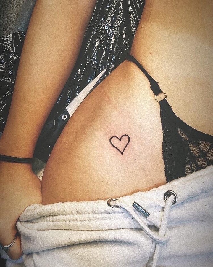 Outline love heart tattoo above the hip for female a sensual statement