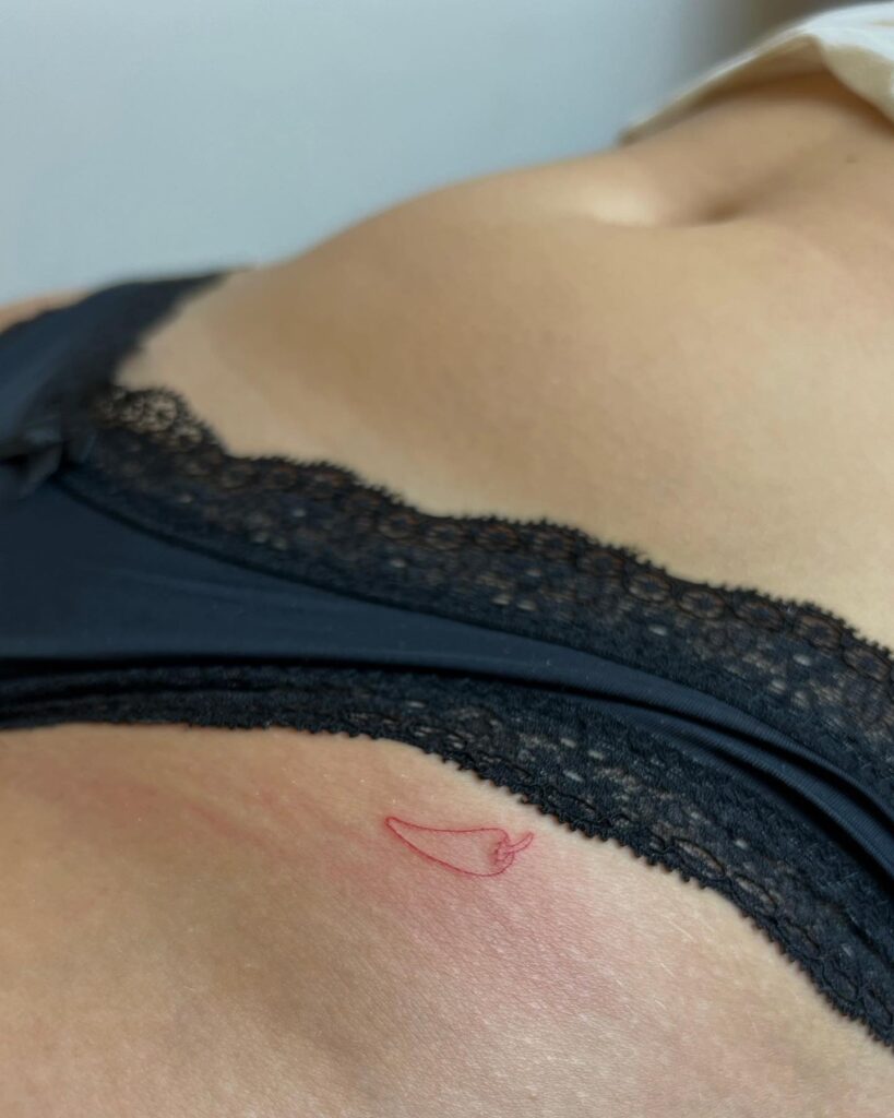 Outline Small Chili Tattoo on the Hip: Spicy Vibes