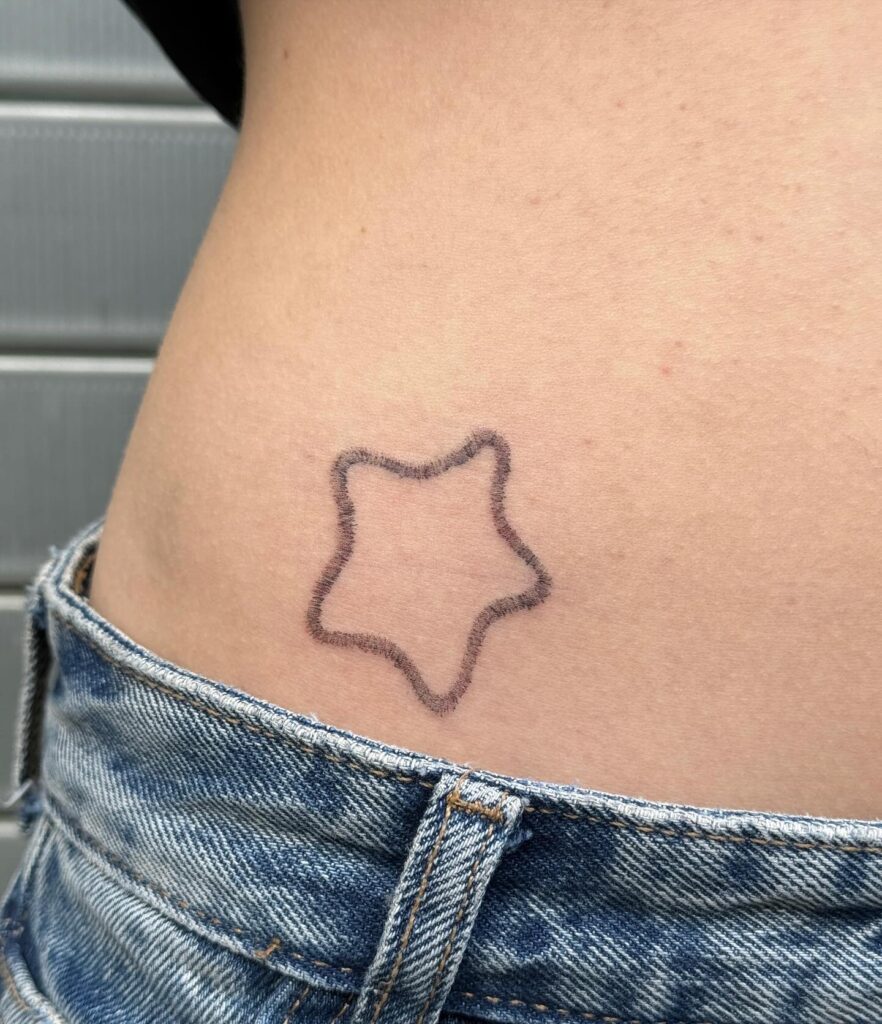Outline Star Tattoo on the Hip, a Celestial Mark of Cosmic Beauty: Stellar Charm