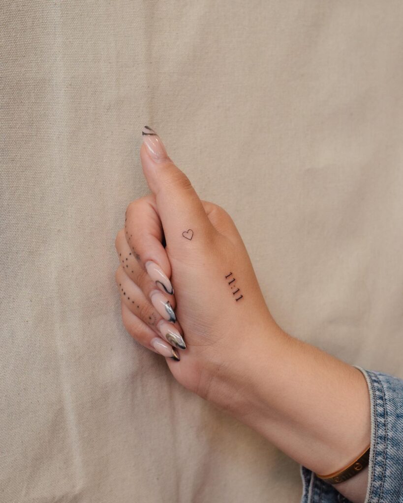 Outline tiny heart tattoo with 1111 for girls capturing special moments