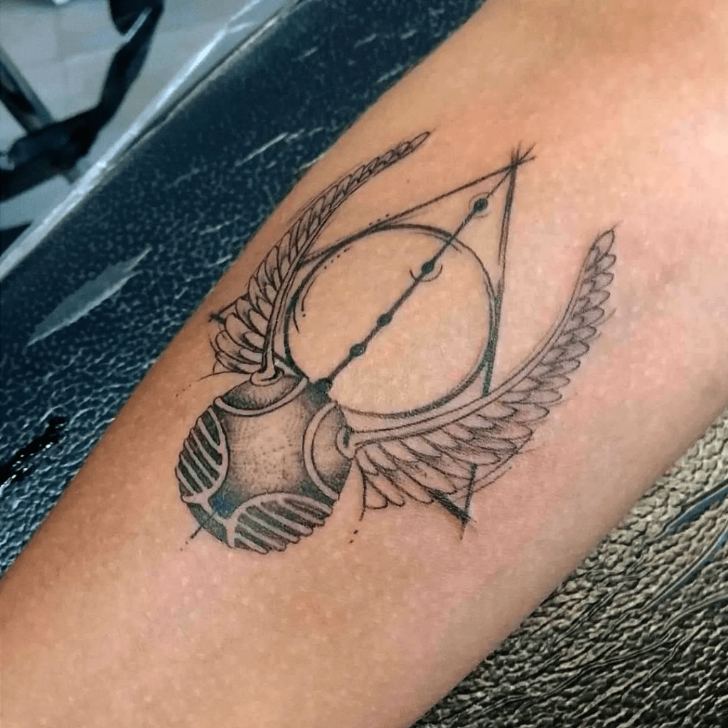 Outlined partially shaded deathly hallows golden snitch tattoo image