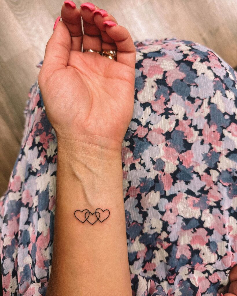 Overlapping hearts three fineline heart tattoos on inner wrist