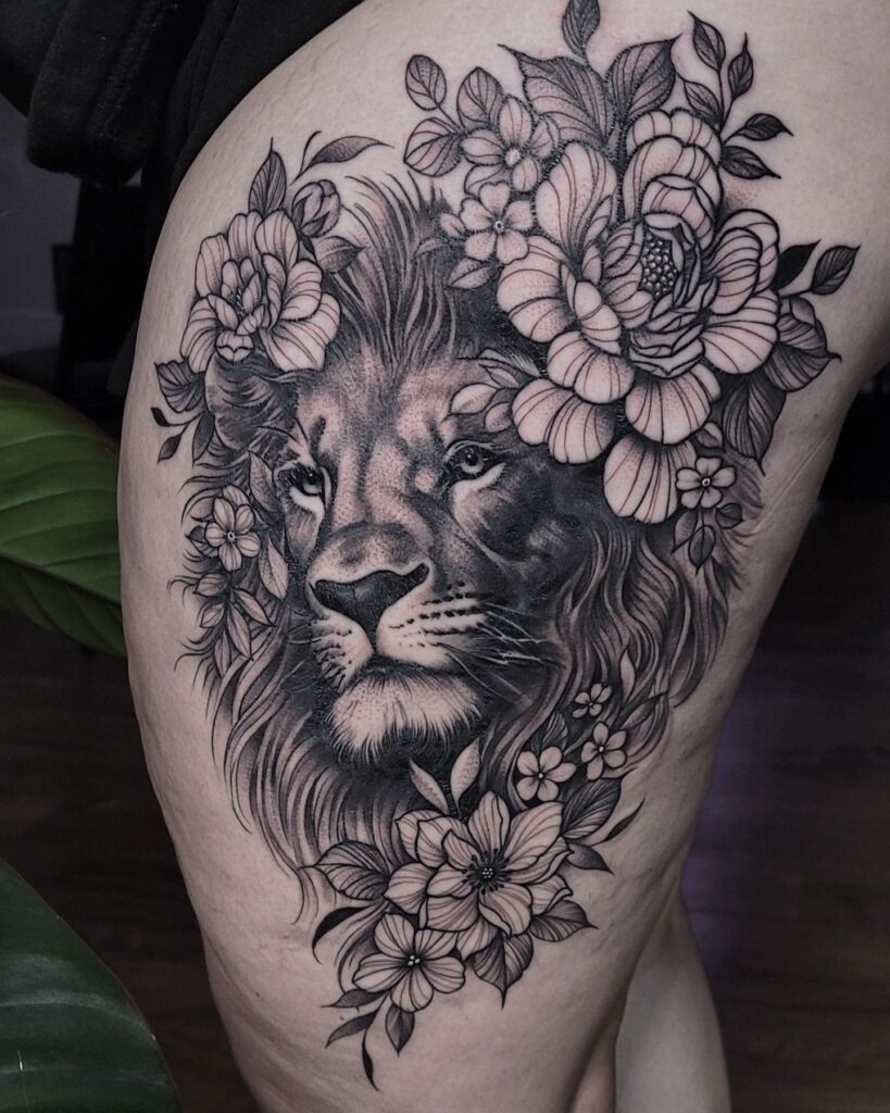 Partially healed lion portrait on the side thigh with floral accents: floral surround
