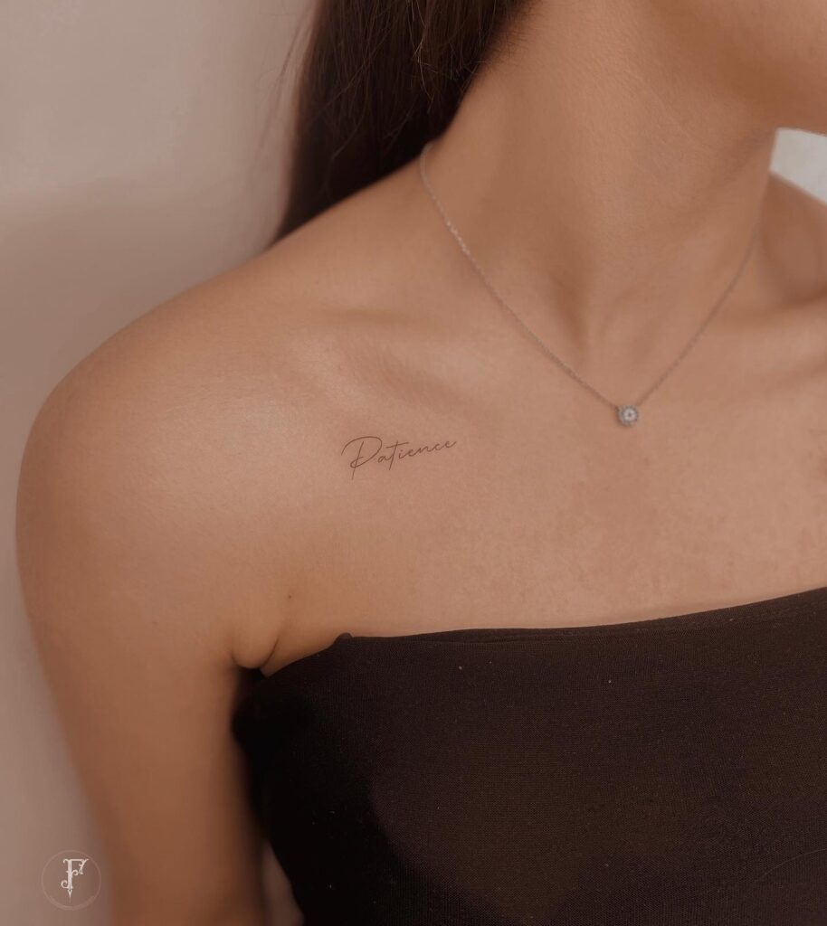 'Patience' cursive lettering handwriting tattoo on the collarbone with a delicate font virtue in ink
