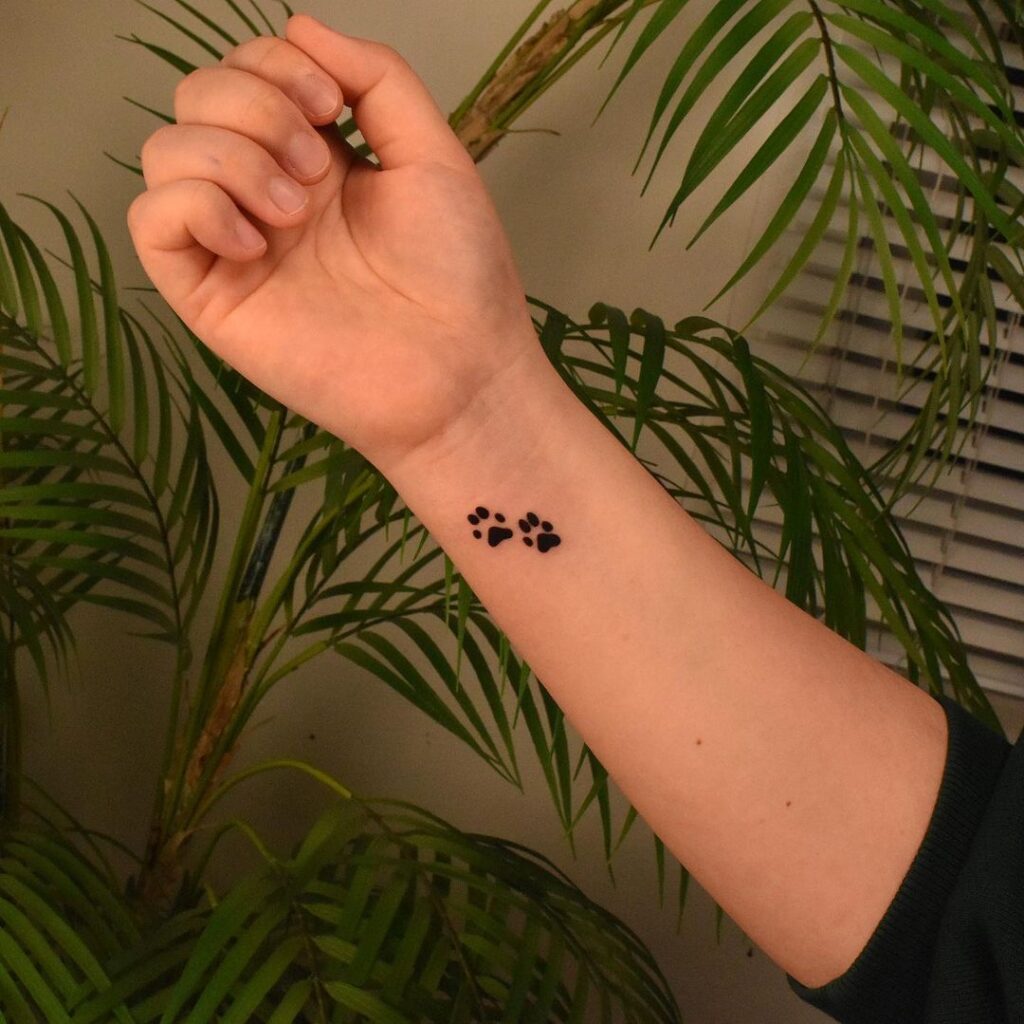 Pawfect tribute wrist paw dog tattoos celebrating canine affection