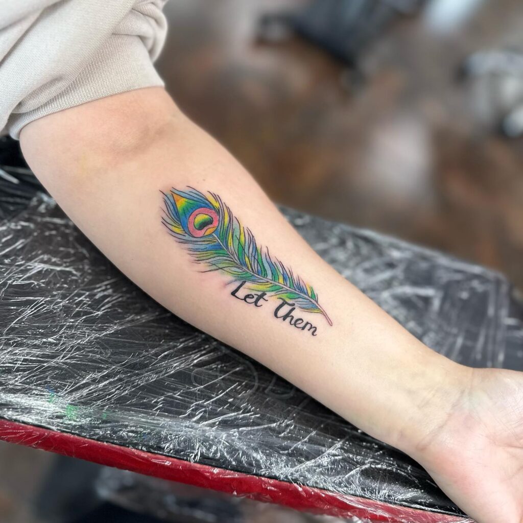Peacock Feather Tattoo with Text Let Them on Hand Empowering Beauty