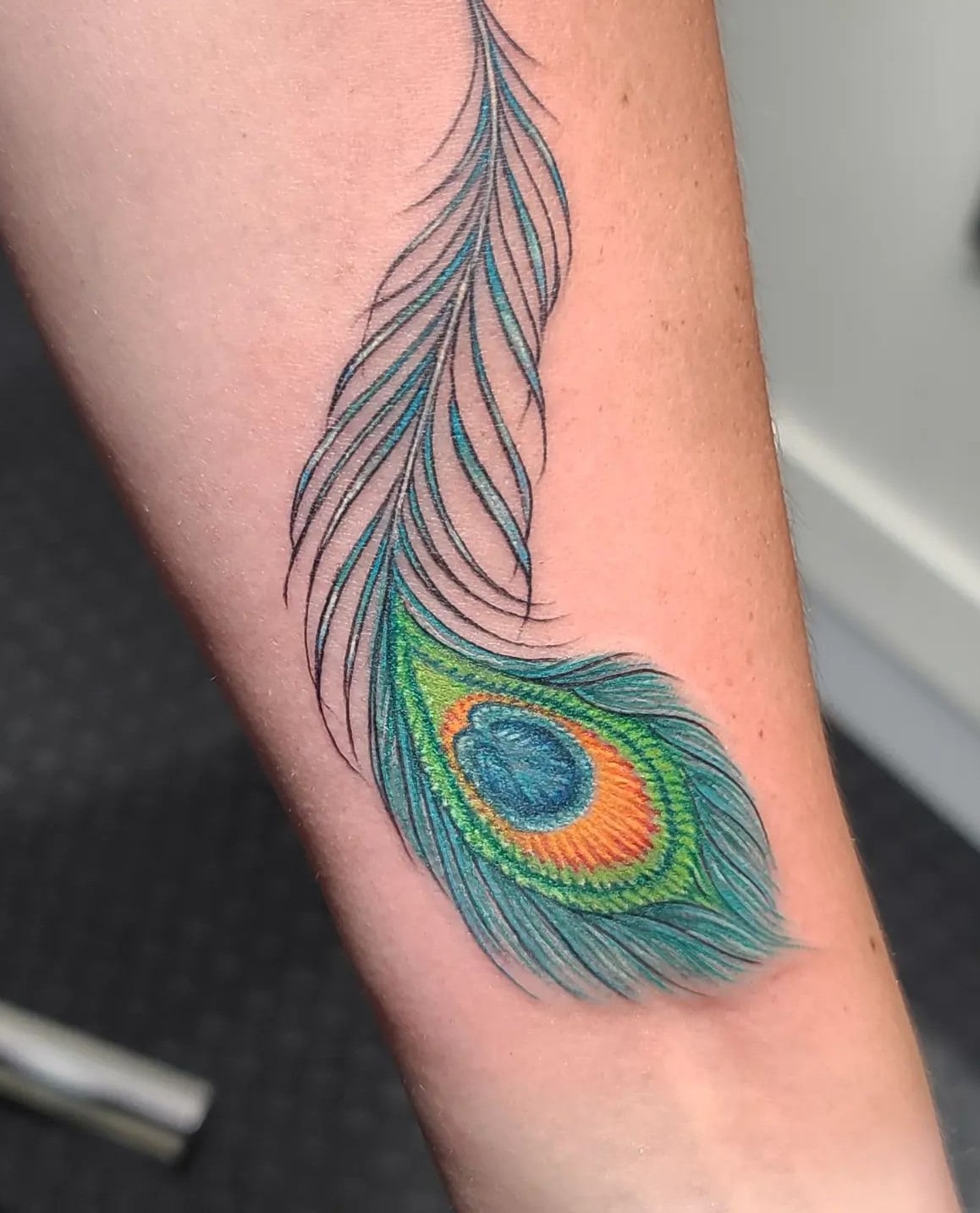 Peacock feather tattoo on hand in green color Peacock feather tattoo on hand in green color