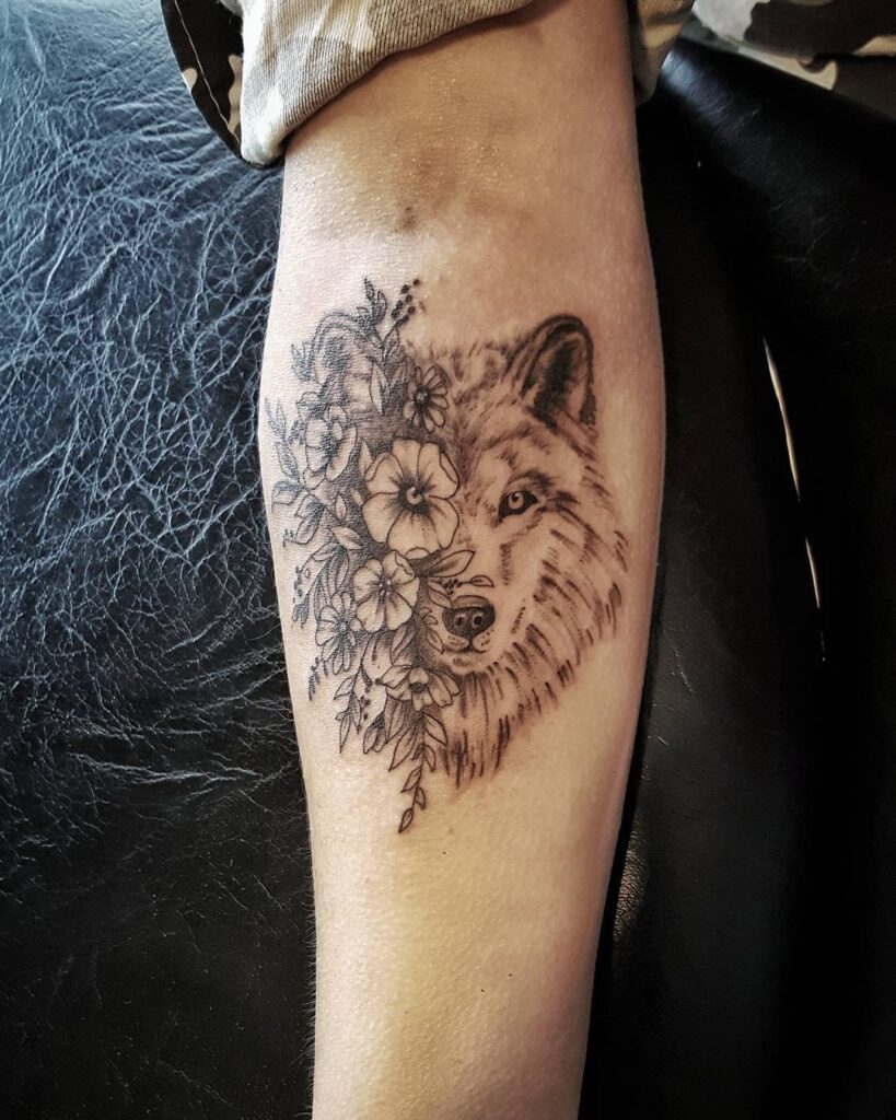 Perfect harmony unique forearm tattoo with wolf and flowers