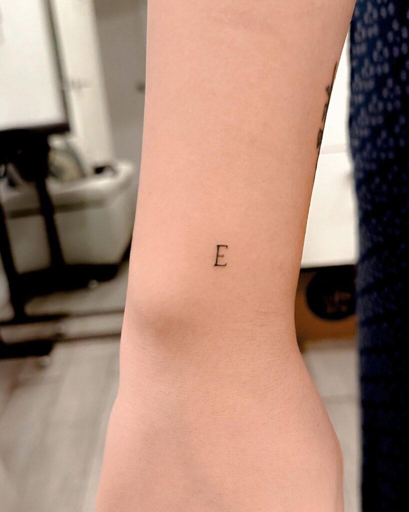 Perfect Tiny 'E' Letter Tattoo on the Outer Wrist: Subtle Elegance