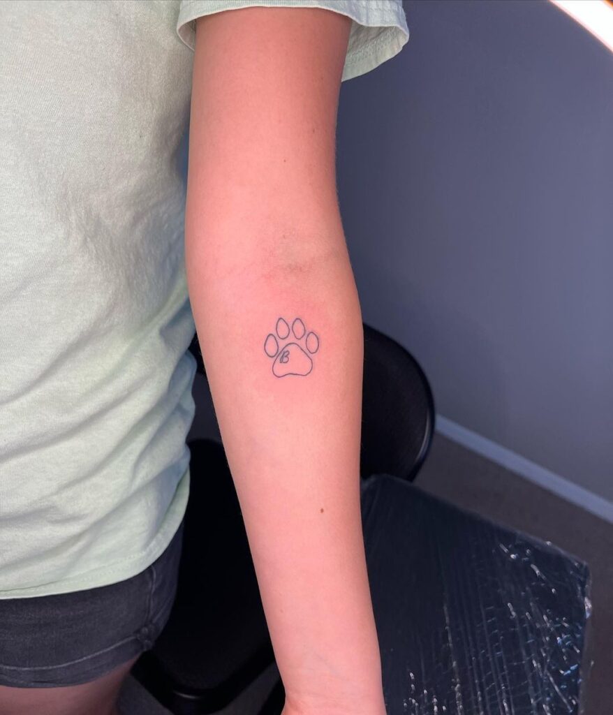 Personalized elegance minimal paw print and 'b' letter on the forearm