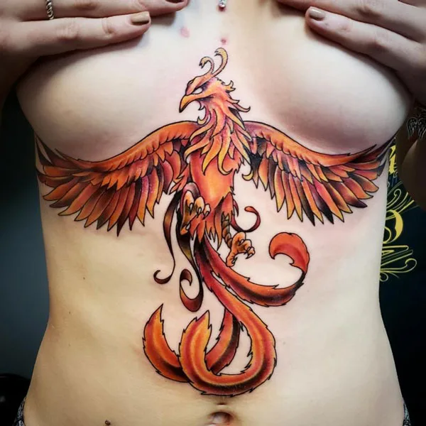 Phoenix under breast tattoo