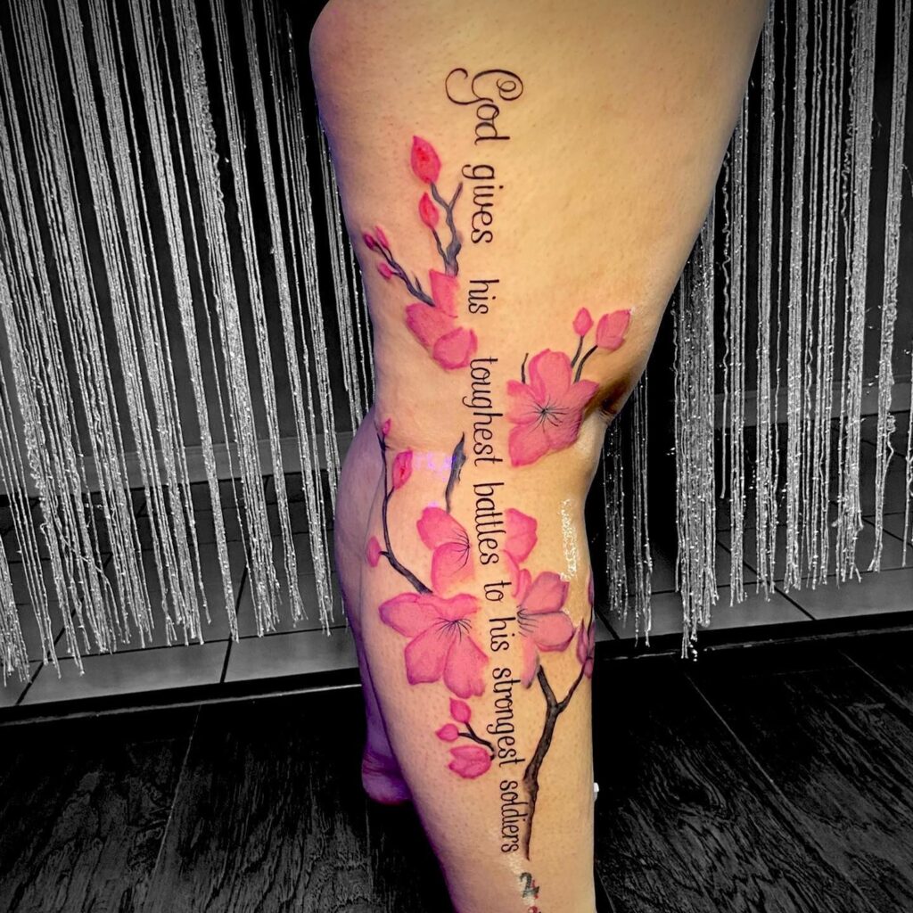 Pink flowers with quote leg tattoo design for women
