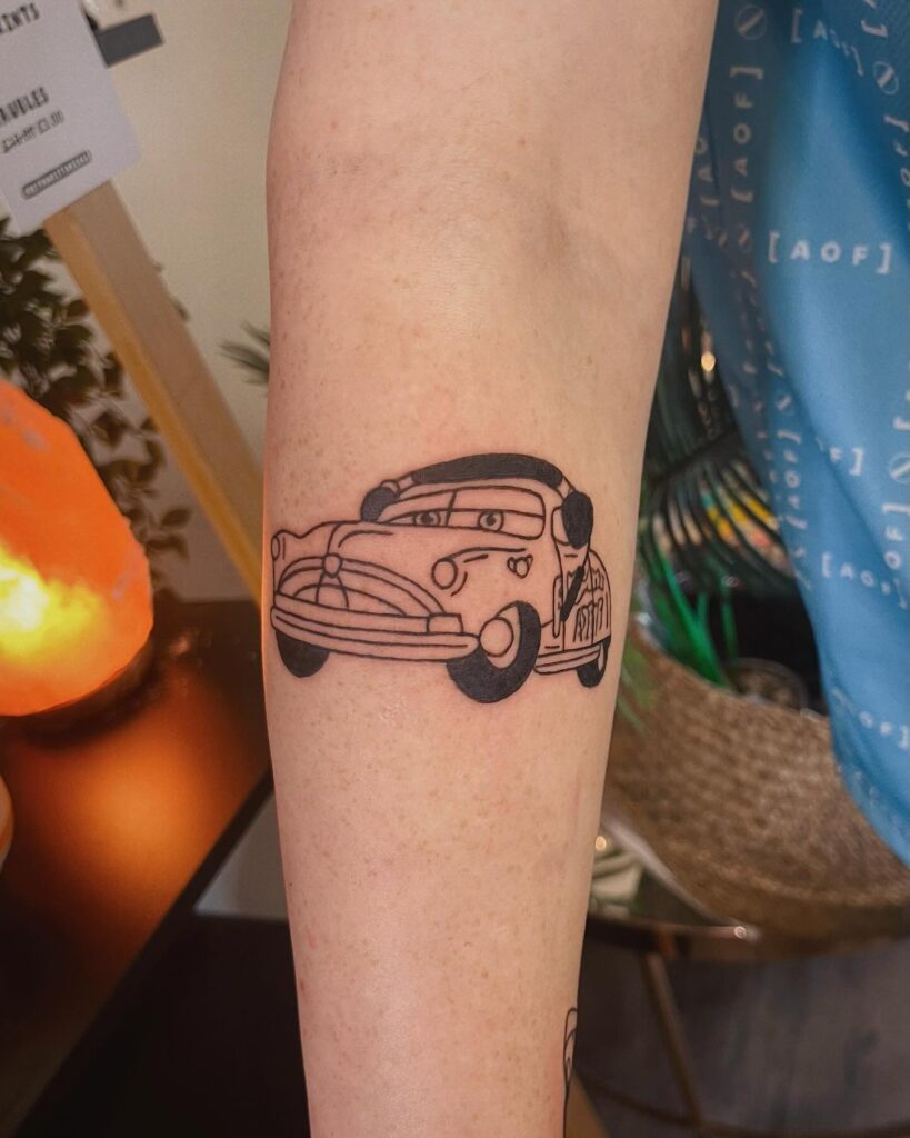 Playful Vintage Car Tattoo in Bold Black Ink Line Drawing on Forearm – Car Tattoo Ideas