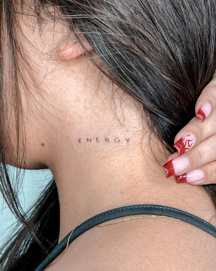 Positive vibes energy word lettering tattoo on the side neck