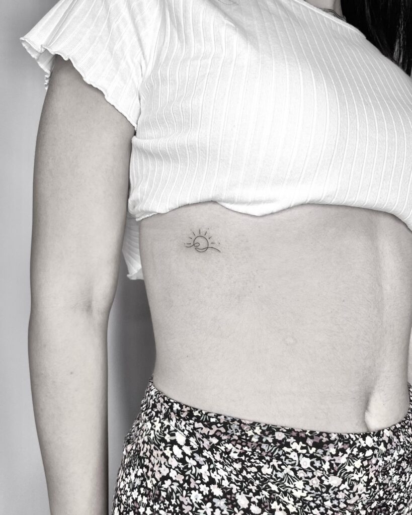 Pretty Rib Fineline Tattoo for a Delicate Look: Sun and Wave Symphony