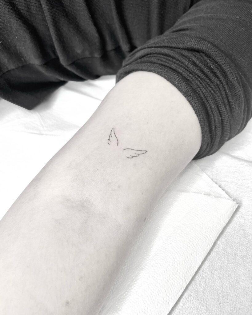 Pretty Small Wings Tattoo Above the Elbow: Delicate Flight
