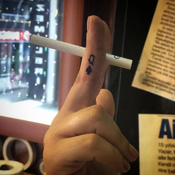 Queen of spade finger tattoo
