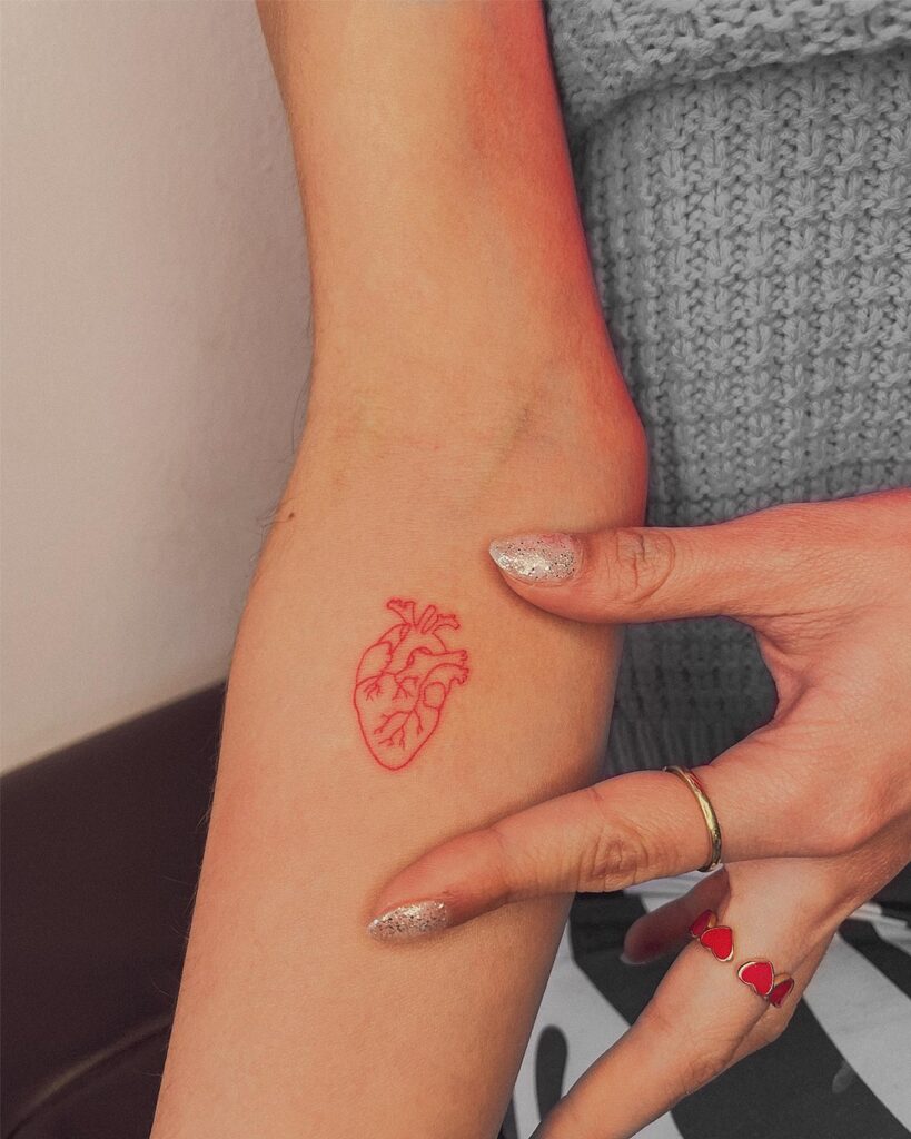 Real Heart in Red Color Fineline Tattoo on the Below the Elbow: Heart's Symphony