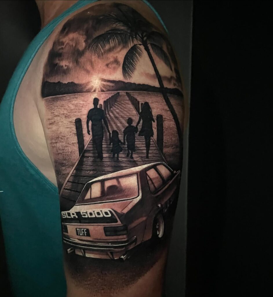 Realism Family Bond Tattoo with SLR 5000 Car and Sunset on Upper Arm – Car Tattoo Ideas