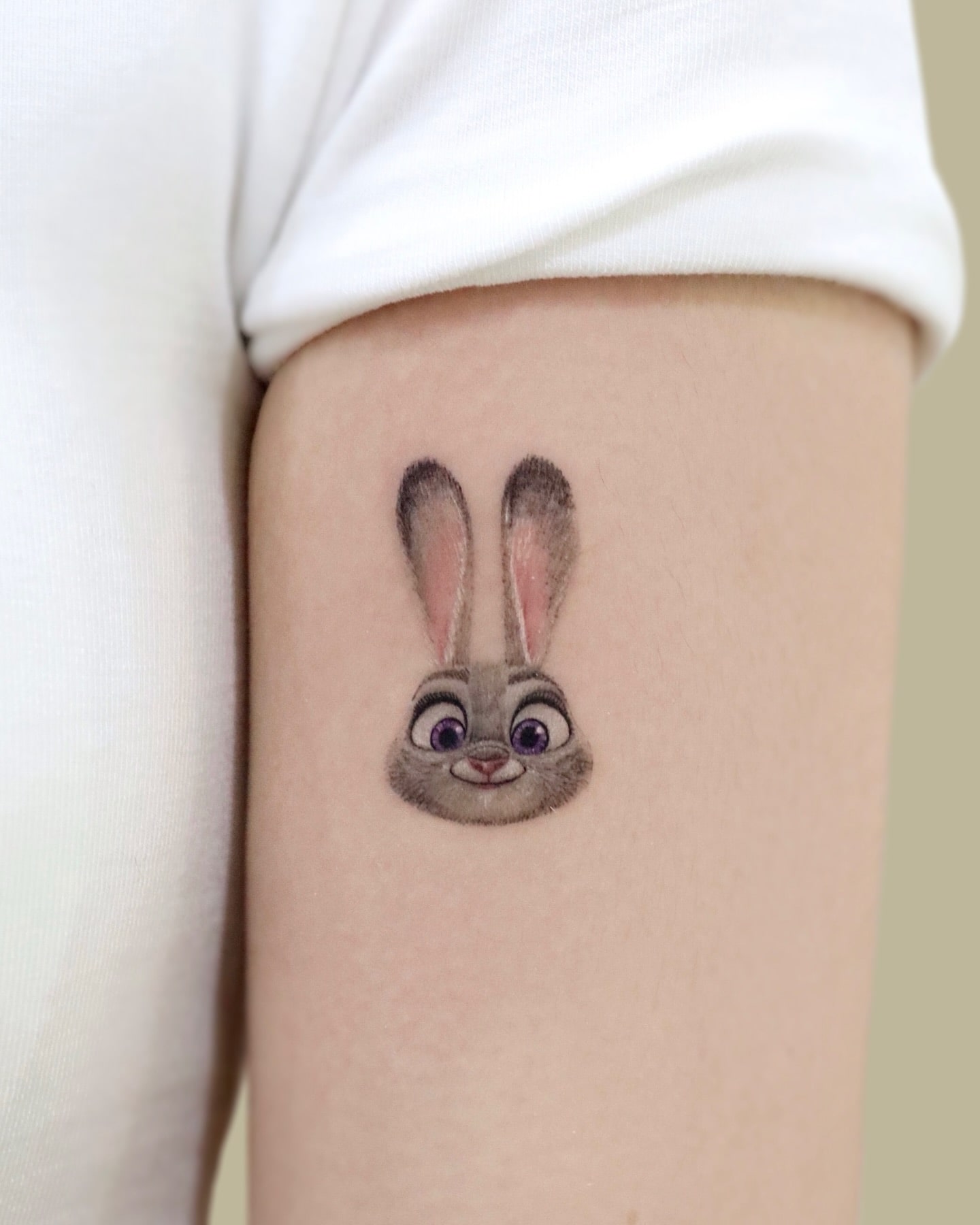 Realistic Judy Hopps bunny tattoo from Zootopia featuring fine details and expressive purple eyes, ideal for lovers of cute and lively animal tattoos