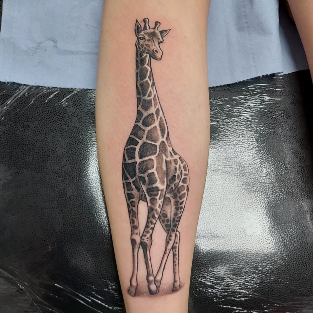 Realistic Baby Giraffe Tattoo with Patterns on the Calf: Giraffe Grace 