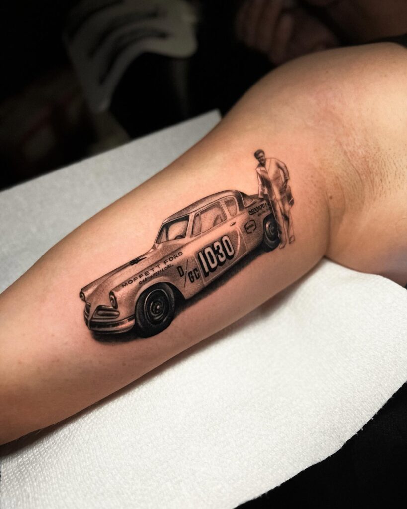 Realistic Black and Grey Vintage Race Car Tattoo with "1030" and "Moffett Ford" on Forearm – Car Tattoo Ideas