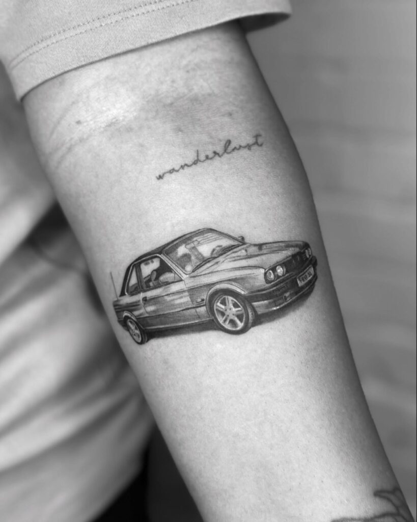 Realistic BMW E30 Tattoo with "Wanderlust" Inscription on Outer Forearm – Car Tattoo Ideas