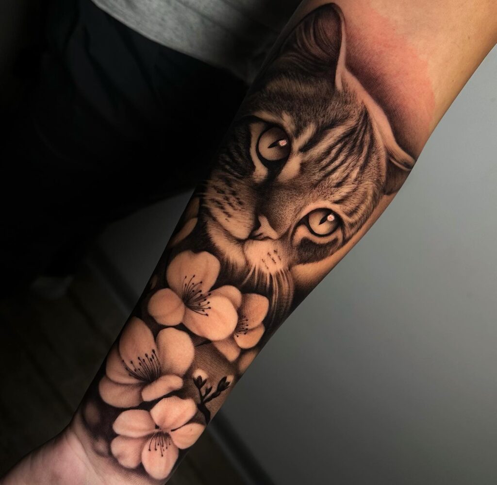 Realistic cat and flower tattoo with soft shading and glowing eyes