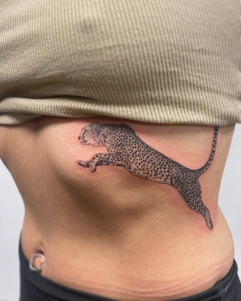 Realistic cheetah running tattoo on the rib with exquisite detailing cheetah sprint