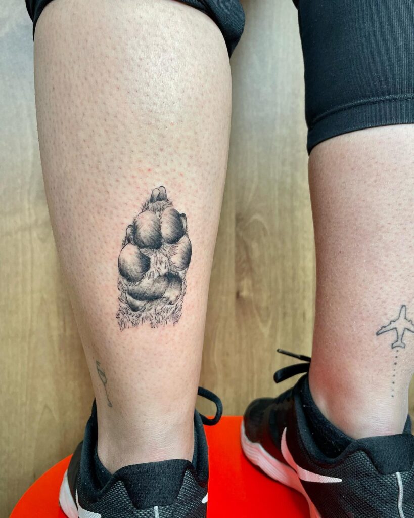 Realistic Dog Paw Tattoo on the Back of the Ankle for a Touch of Realism: Calf Companion