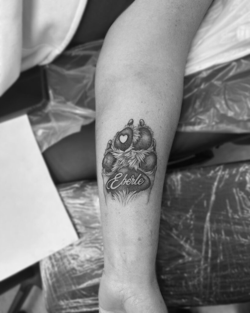 Realistic Dog Paw Tattoo on the Forearm with 'Eberle' Lettering: Forearm Fidelity