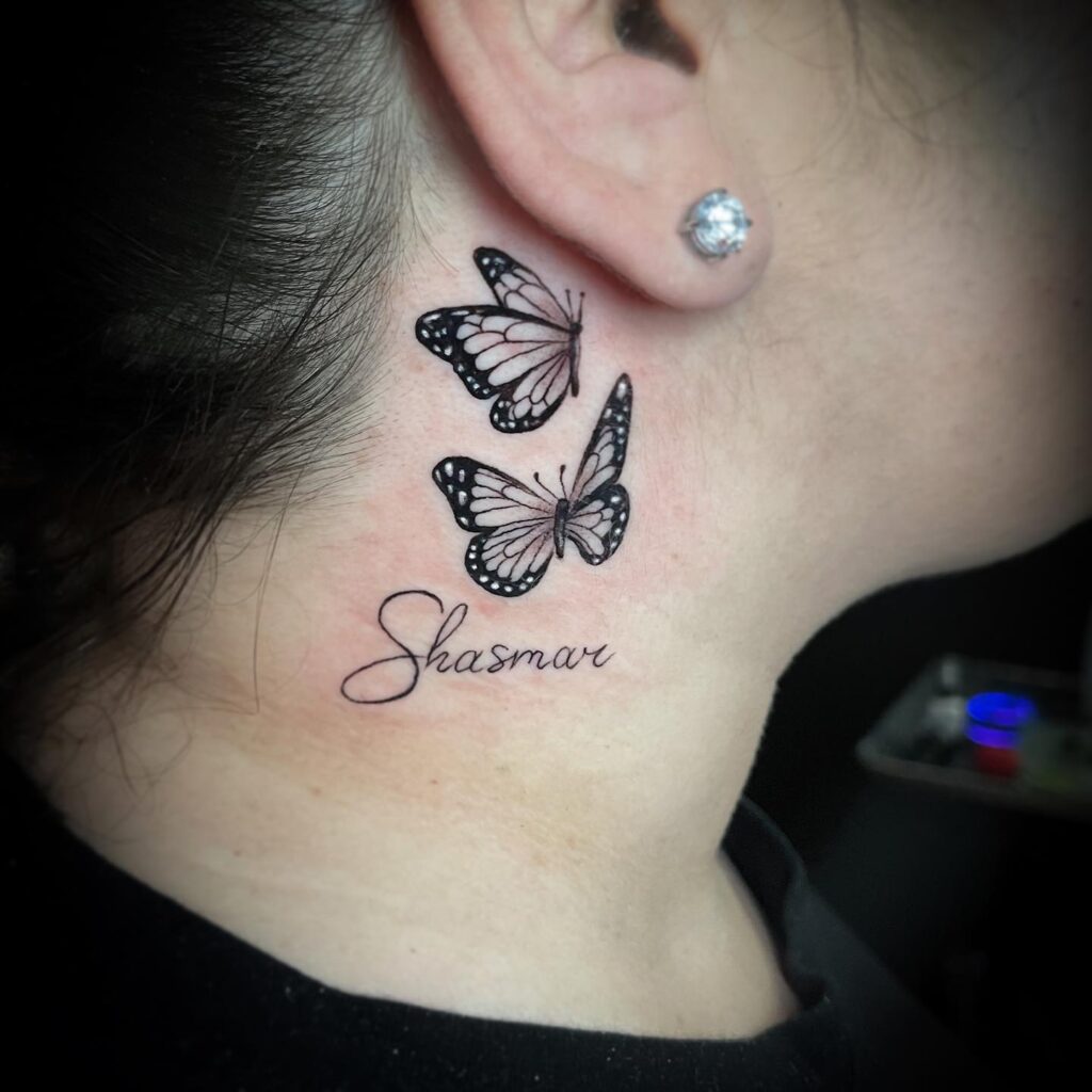 Realistic duo in motion two butterflies with meaningful text behind the ear
