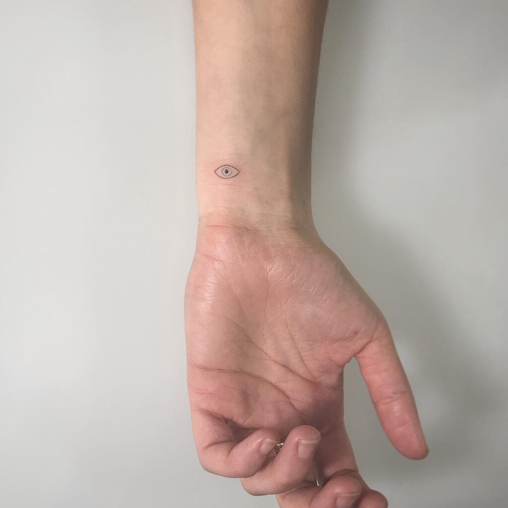 Realistic evil eye inner wrist tattoo dive into the detailed craftsmanship of symbolic ink