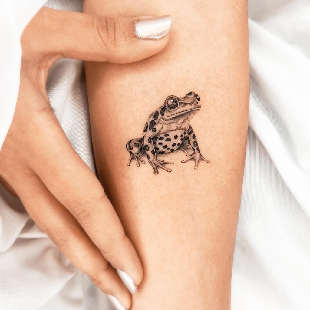 Realistic Frog Tattoo in Black and Grey, Leaping on the Forearm: Amphibian Charm