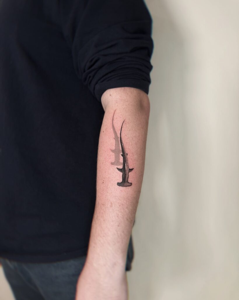Realistic hammerhead shark forearm tattoo with soft shading and depth