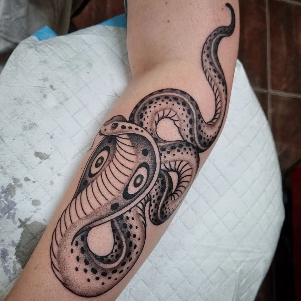 Realistic king cobra tattoo on the side forearm majestic serpent portrait
