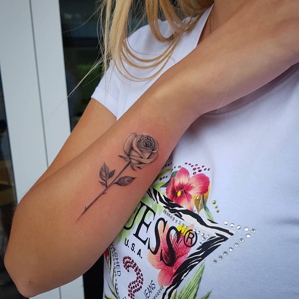 Realistic minimal single rose outer forearm tattoo ideas