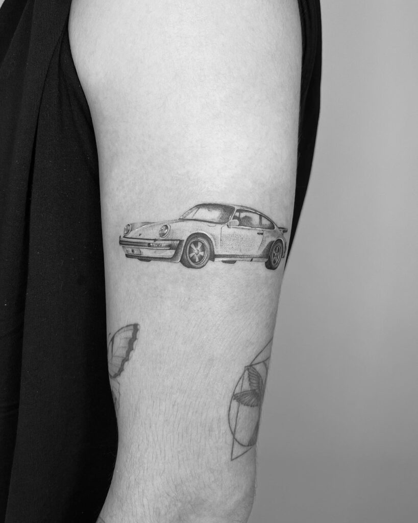 Realistic Porsche 911 Tattoo with Smooth Shading and Fine Linework on Forearm – Car Tattoo Ideas