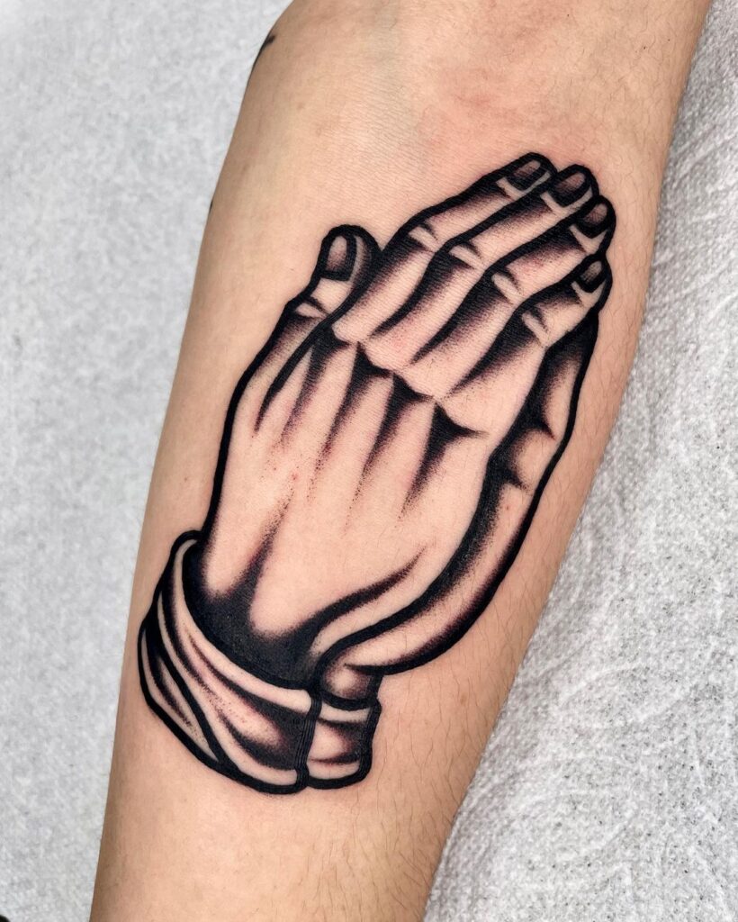 Realistic praying hands forearm black and grey tattoo