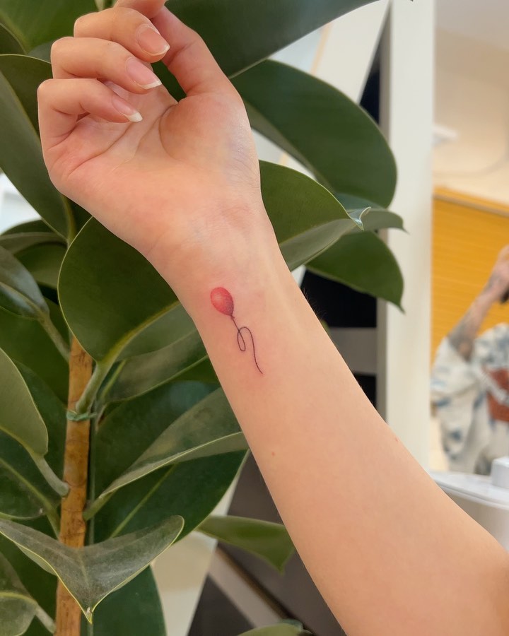 Realistic red balloon wrist tattoo elevate your style with balloon ink art