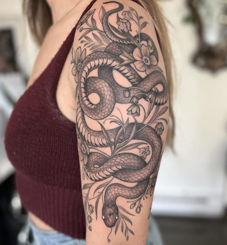 Realistic snake in the grass half sleeve tattoo for women slithering elegance