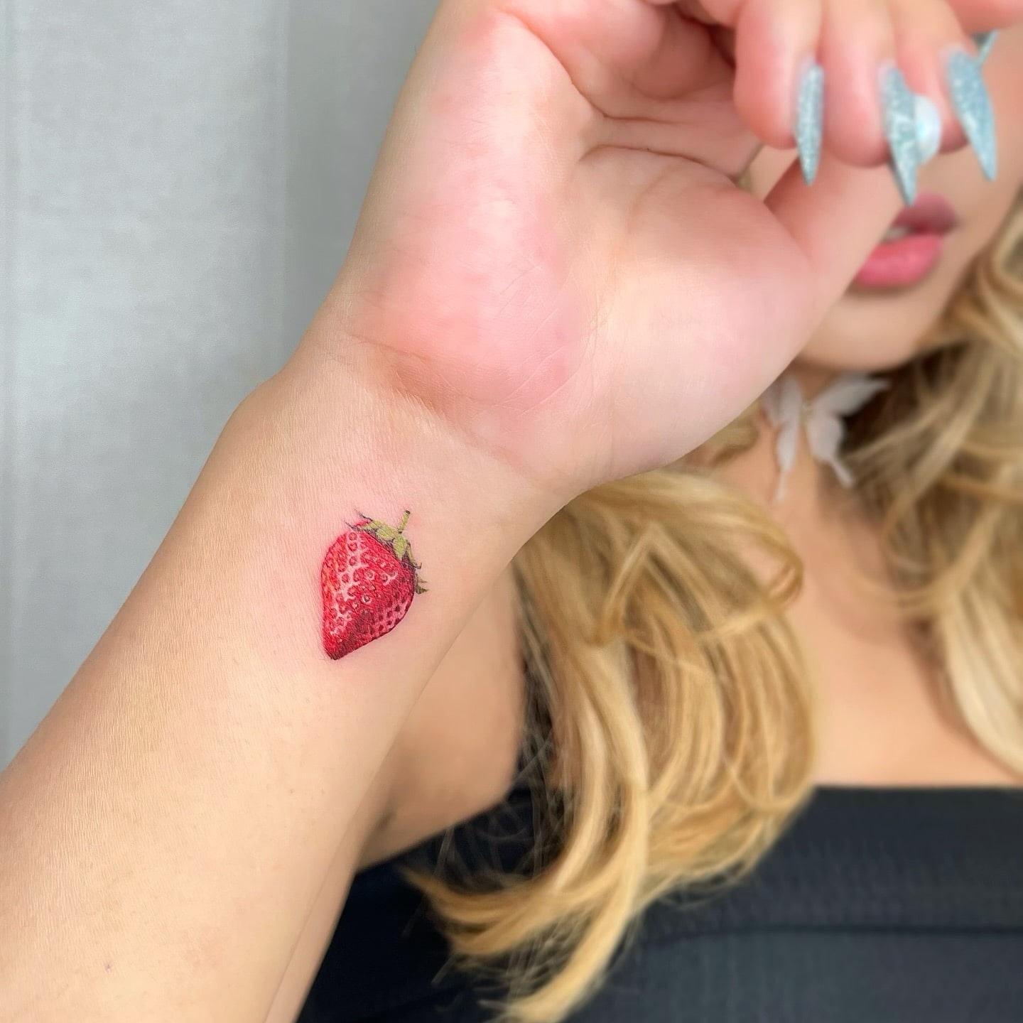 Realistic Strawberry Wrist Tattoo Colorful and Playful Tiny Fruit Design