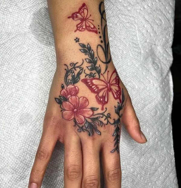 Red butterfly hand tattoo