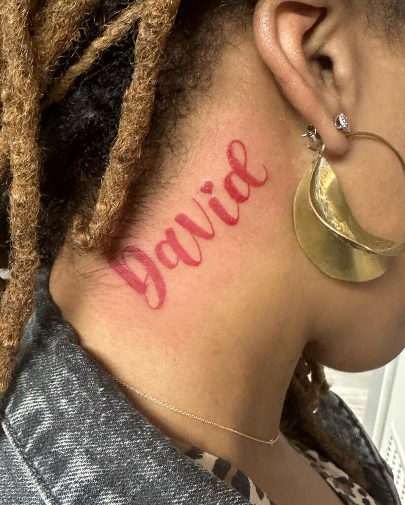 Red Cursive Name Tattoo on Neck David Design with Heart Symbolizing Love
