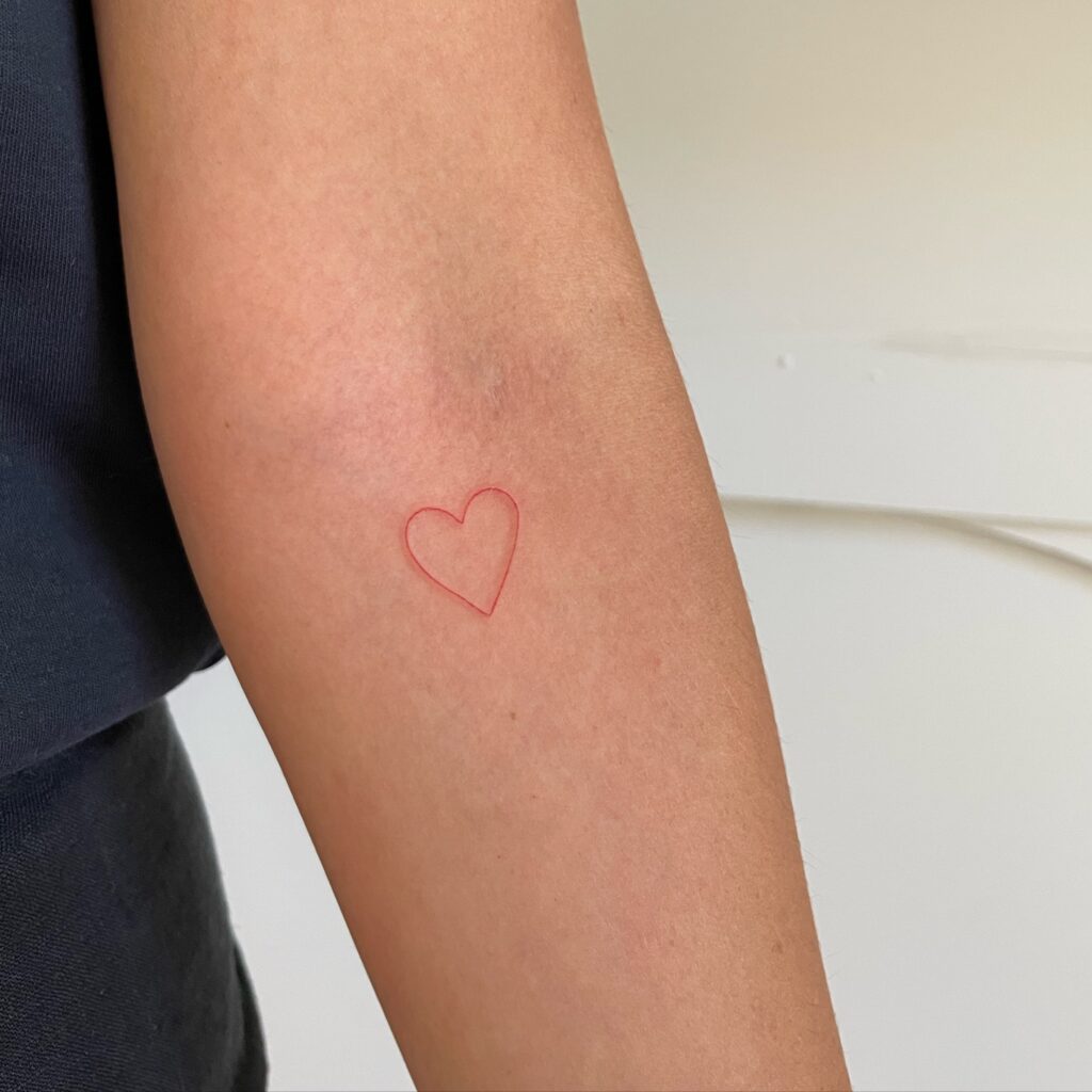 Red Heart Shape Tattoo Below the Elbow: Passionate Outline