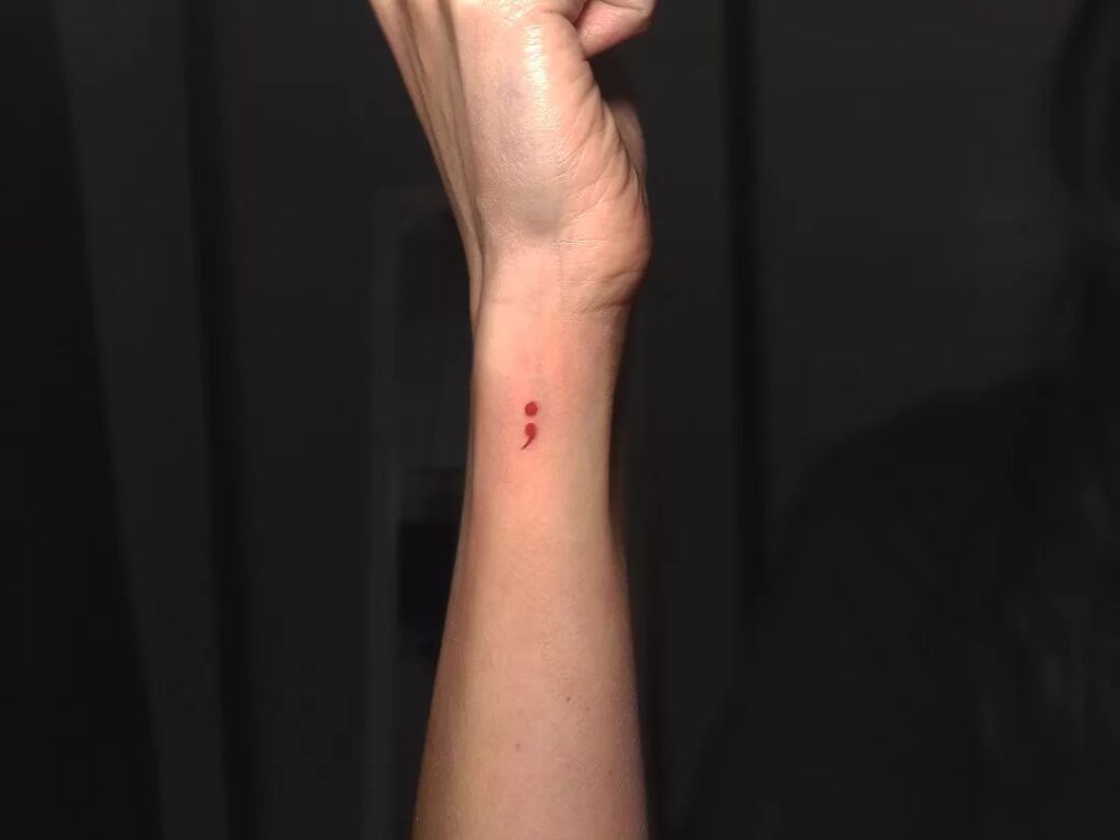 Red Semicolon on the Side of the Wrist: Pop of Color