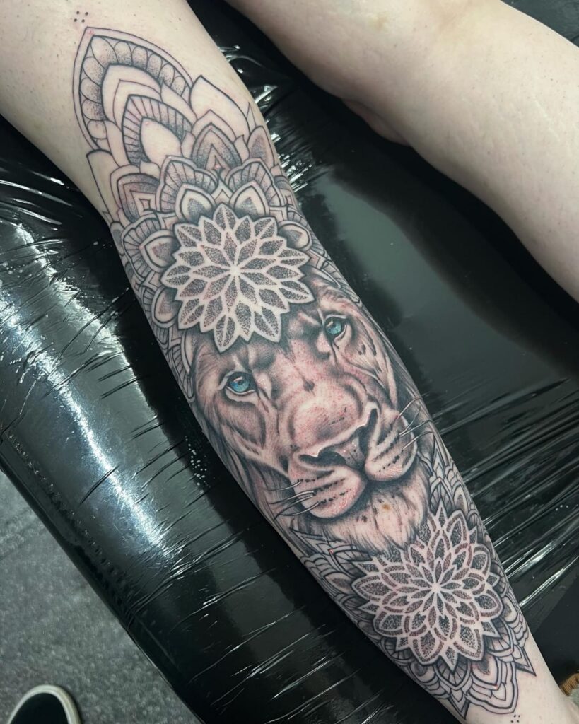 Regal lion face and mandala calf tattoo geometric elegance 