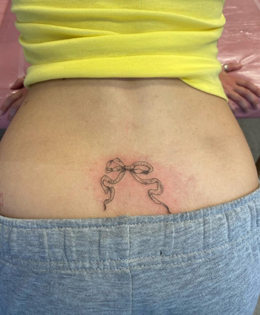 Ribbon Bow Tattoo on the Lower Back for Women: Feminine Elegance
