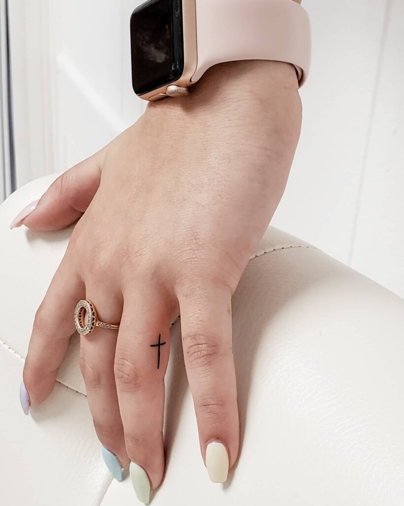 Ring finger side small cute simple cross tattoo designs