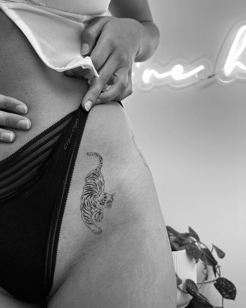 Roaring Tiger Tattoo with Intricate Patterns on the Hip, a Majestic Display: Ferocious Elegance